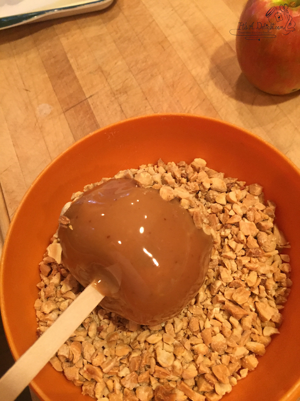 dip and roll the apple in chopped peanuts