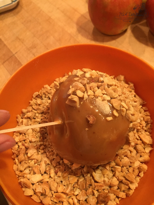 dip and roll the apple in chopped peanuts